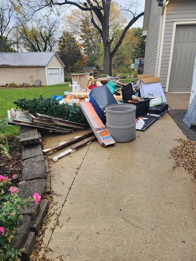 Dumpster being loaded with debris for Roofing Dumpster Rental in Sandstone